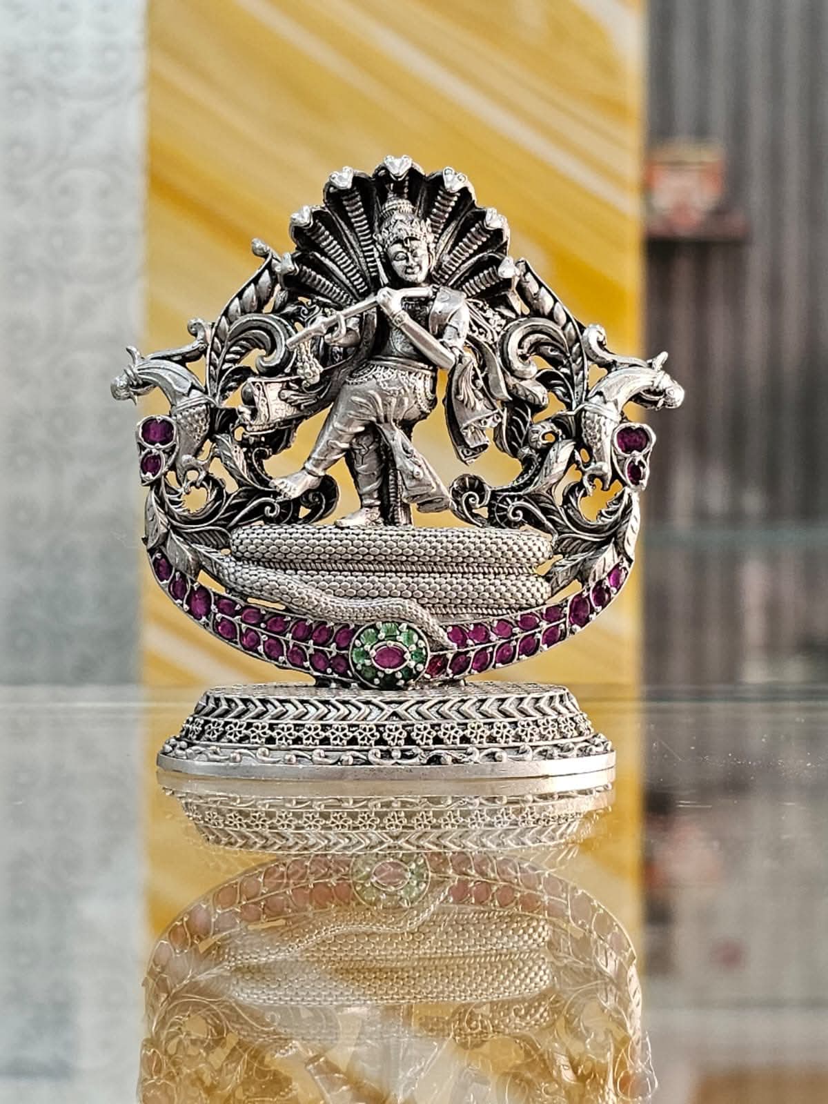 Silver idol with stones